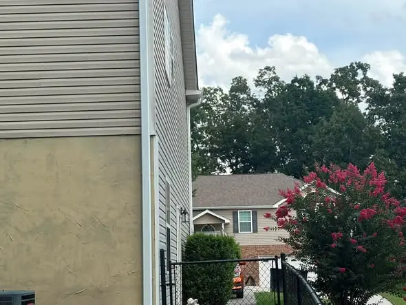 White 3x4 downspout on a Chattanooga home corner